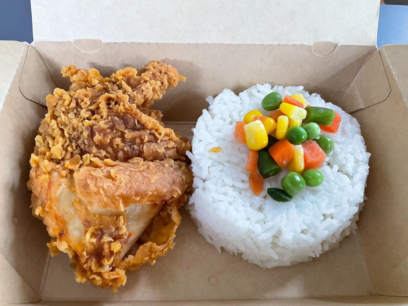 Chicken and rice, served with white rice and mixed vegetables.