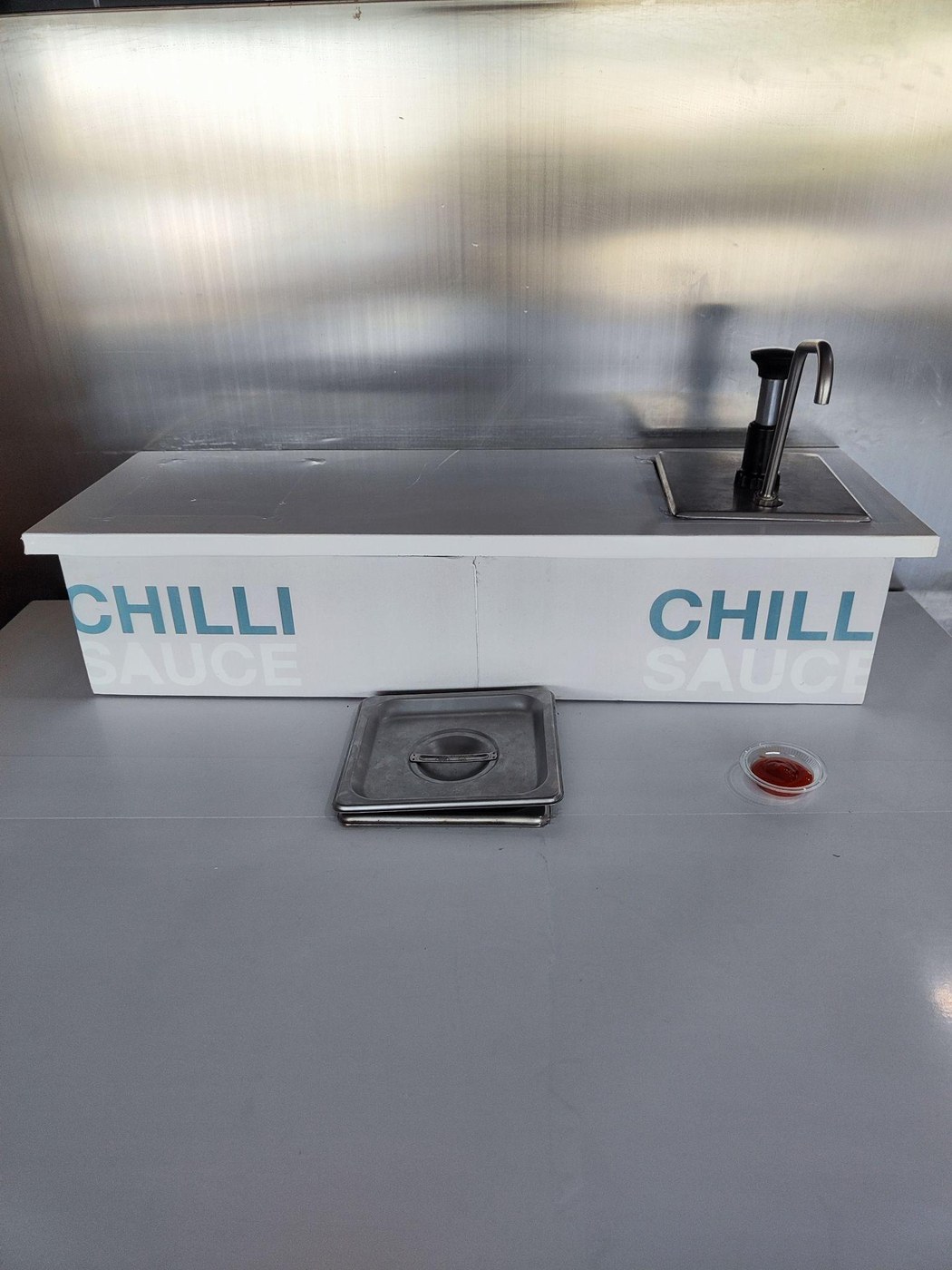 A free-flow sambal dispenser.