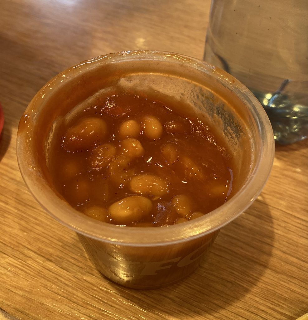 A very British side — baked beans, in a very small box.